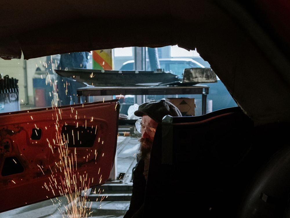 Welding sparks inside a stripped car shell