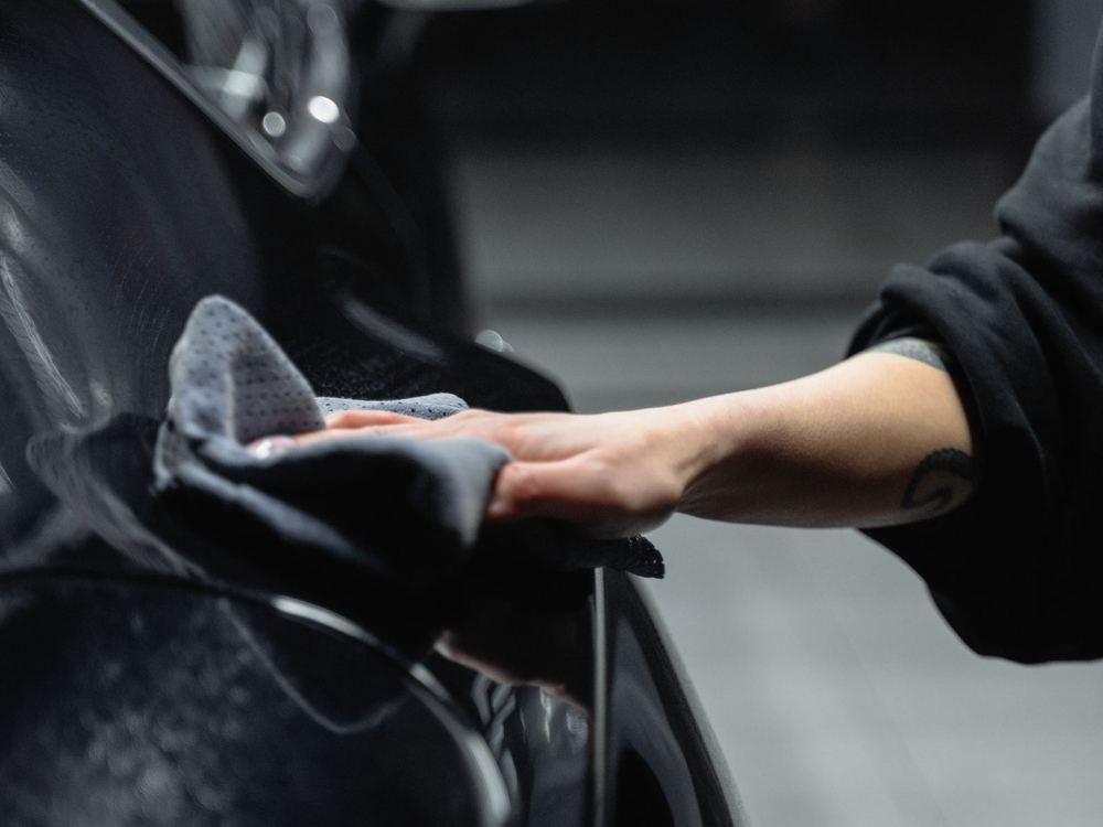 Hand buffing a deep black finished panel